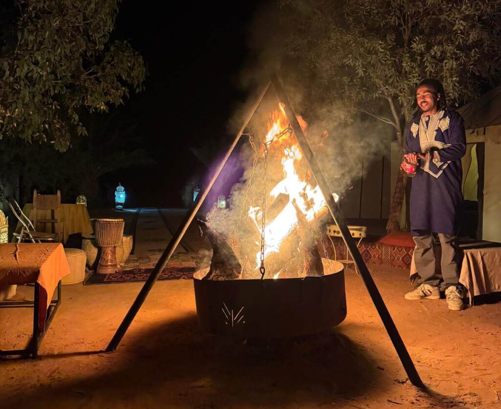 Merzouga Desert Tour – Camel Trek, Desert Camp & Sahara Sunrise traditional Berber campfire at night in Merzouga desert camp Morocco